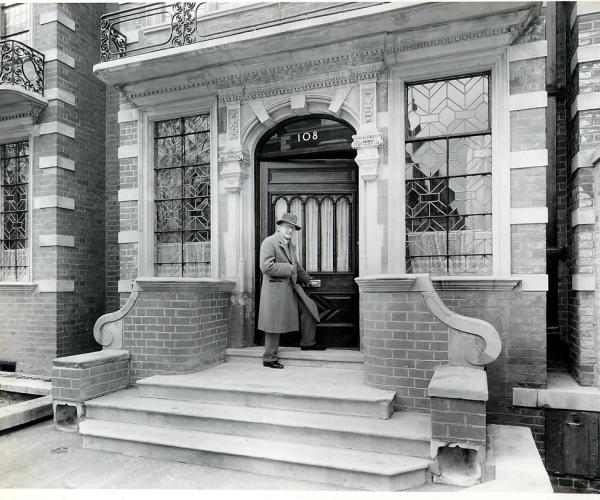 Cecil Thomas OBE FRBS entering Dora House 