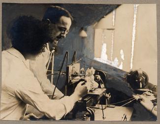 Cecil Thomas working on the cutting of a Buddha in crystal