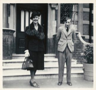 Black and white photo of mother and son outside Dora House