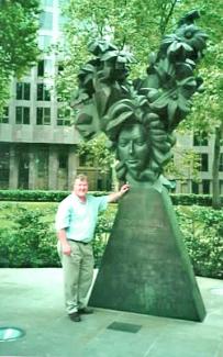 Glynn Williams FRSS next to his public art commission, The Flowering of the English Baroque (1994) a memorial to composer Henry Purcell