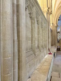 Installation view of "In the Shimmering Air" by Caro Williams at Wells Cathedral. Suspended brass text and sound notes shimmer in the North Quire Aisle.