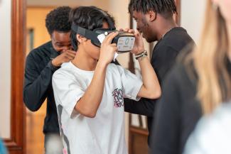 Student viewing 360 tour through virtual reality helmet