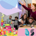 Blue and white striped semi-circle, purple quadrilateral, man and boy making post-it note sculpture, boy in red jumper using interactive whiteboard spray paint can, two young girls laughing and reaching for a glue stick. 
