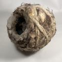 Burrow 2025. Plastic land drain, agricultural twine, barbed wire and chicken wire bound with felted insulation wool - natural and artificial. All salvaged materials from the countryside that link to biodiversity loss yet through their fusion explore the possibility of adaptation and evolution.