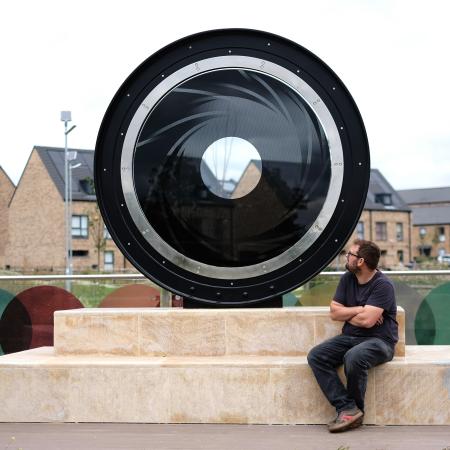 Tom Waugh MRSS with his sculpture The Lens