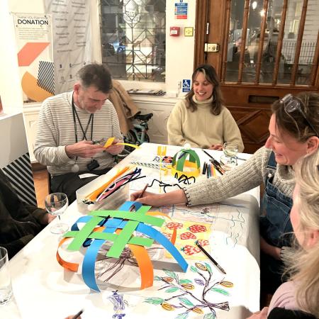 A group of educators playing a cooperative drawing and making game