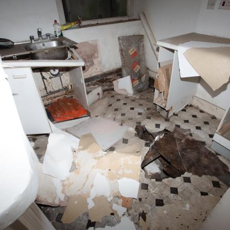 Rotten, collapsed floor in kitchen